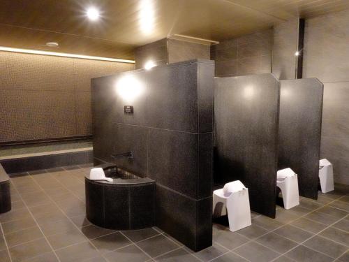 a bathroom with a sink and two urinals at Hotel Elcient Osaka Umeda in Osaka