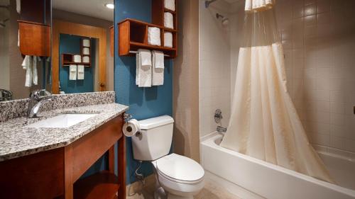 A bathroom at Days Inn by Wyndham Englewood Dayton Airport