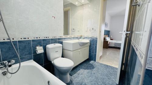 a bathroom with a toilet and a sink and a tub at Villa Anastasia ,150 m to Coral Bay beach in Peyia