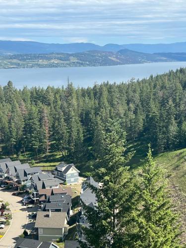 an aerial view of a village with trees and a lake at La Casa Lakeside Resort - Amazing Panoramic View Lakeside House with Pools, Hot Tubs & More! in Kelowna