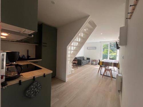 une cuisine et un salon avec un escalier dans une maison dans l'établissement Appartement rénové proche Digue Sainte-Barbe à Saint-Jean-de-Luz avec parking gratuit - FR-1-239-1073, à Saint-Jean-de-Luz