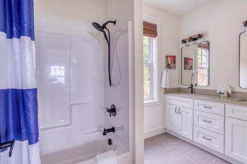 a white bathroom with a shower and a sink at Searenity Now Depoe Hills in Depoe Bay