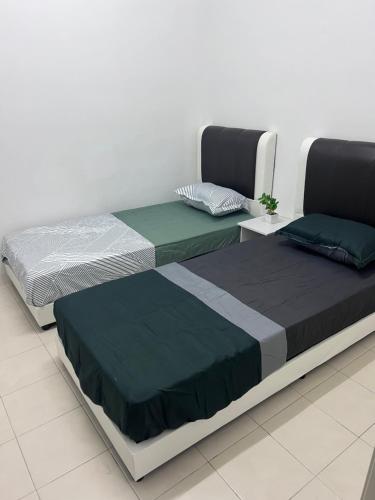 Ένα ή περισσότερα κρεβάτια σε δωμάτιο στο Ayaan Cozy Homestay Cameron Highland