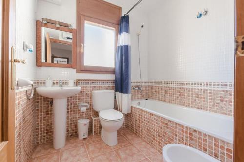 a bathroom with a toilet and a sink and a tub at Casa Azahara by MarCalma in El Casalot