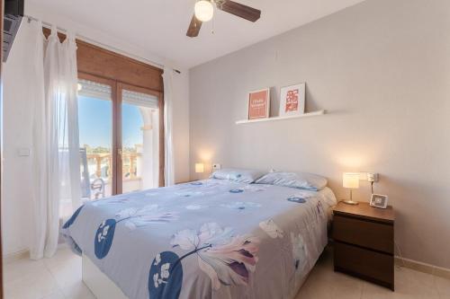 a white bedroom with a bed and a window at Casa Azahara by MarCalma in El Casalot