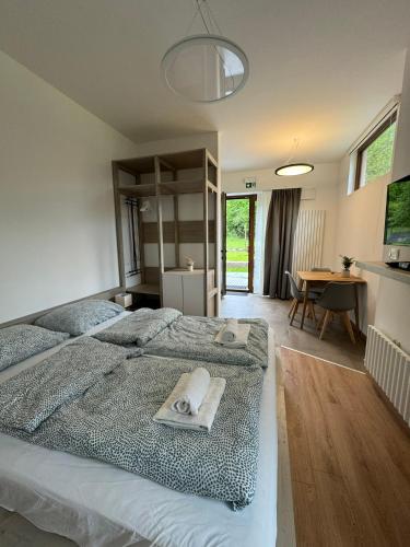 a bedroom with a large bed with towels on it at Apartment Nona Polda in Kobarid