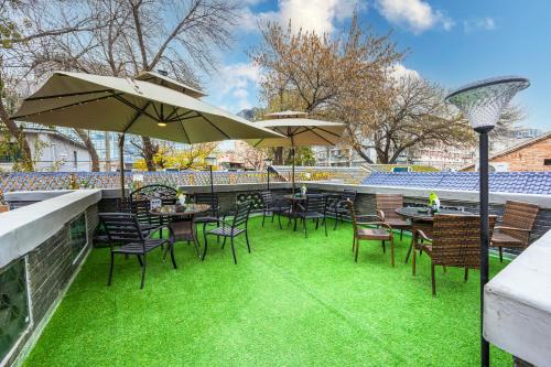 a patio with tables and chairs and an umbrella at The Hutong Courtyard-Very close to Tiananmen Square,Forbidden City,Wangfujing Commercial Street,The hotel has a terrace,Free coffee,Free laundry,Near the subway st ation in Beijing