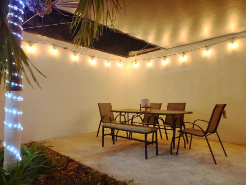 a table and chairs in a room with lights at Hogar Pavo Real in Cancún