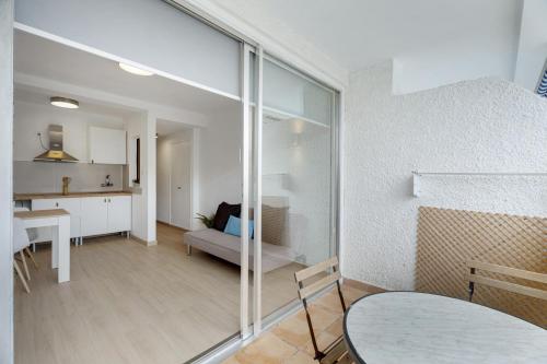 a living room with a table and a dining room at Apartamento Playa Honda in Playa de las Americas