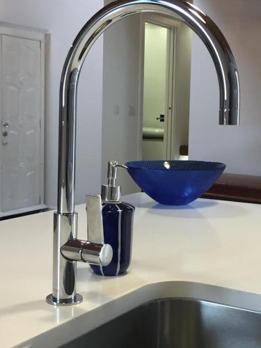 a bathroom counter with a sink and a blue bowl at Loft beach in Vieira de Leiria