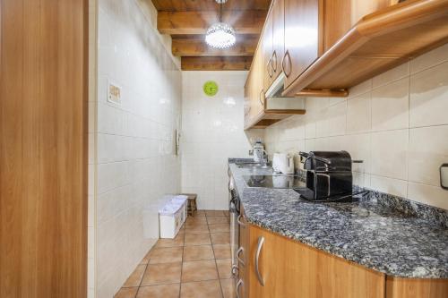 a kitchen with a sink and a counter top at El Raco De Cal Maró in Vall de Castellbò
