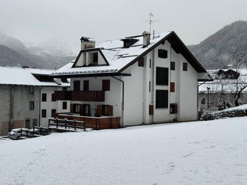 a white house with snow on the ground at Sole e Neve -Sun & Snow in Forno di Zoldo