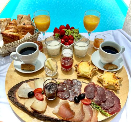 a table with a plate of food and drinks at Residence Canella in Sari Solenzara