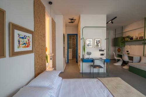 a bedroom with a bed and a desk in a room at Infinity Blue next to the sea in Kalamata