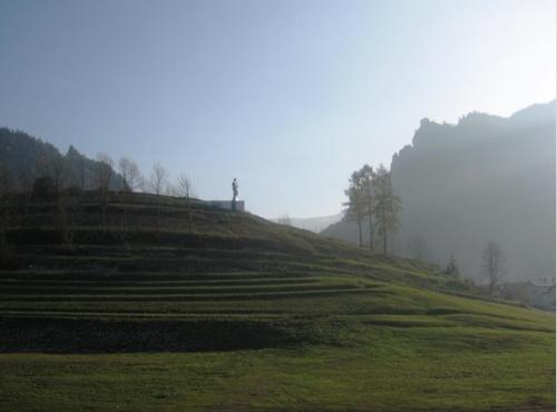 a grassy hill with trees on top of it at Hotel Gold in Terchová