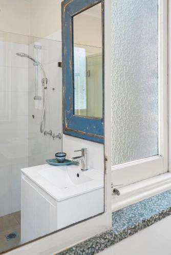 a bathroom with a sink and a mirror at Manly Harbour in Sydney