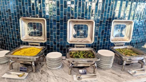 a group of three sinks with different types of food at Ohana Village in Phương Phi