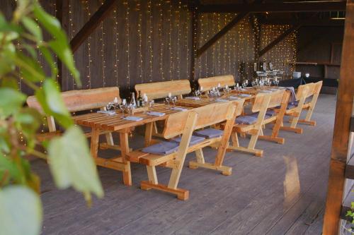a long wooden table with chairs and wine glasses at Hotel Franziskushöhe Lohr in Lohr