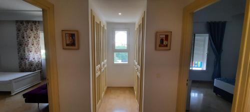 a hallway with a room with a bed and a window at Le Bleu Céleste in Hammamet