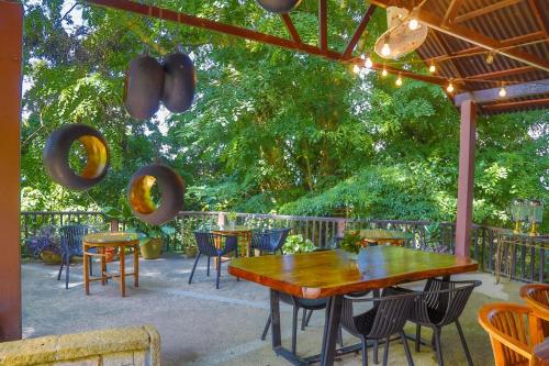 a patio with a table and chairs and trees at The Dusun in Seremban