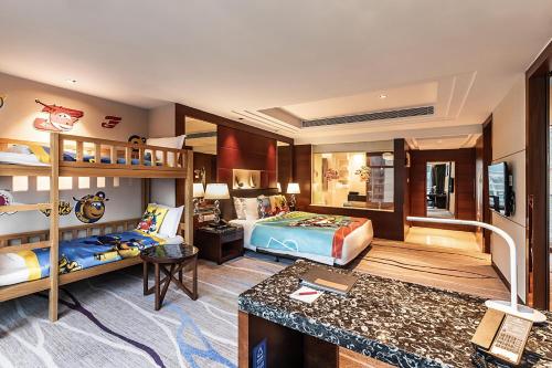 a bedroom with two bunk beds and a desk at Swiss Grand Xiamen-Harbour View in Xiamen