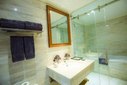 a bathroom with a sink and a shower and a tub at Hai Phong Tower - Apartment & Hotel in Hai Phong