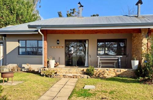 a home with a stone retaining wall and a house at Mill Cottages - Rosetta in Rosetta