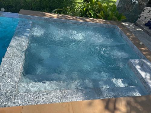 a swimming pool with water in it at Coco Golf Villa in Ban Huai Luk (1)