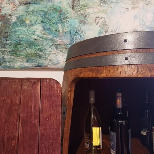 two bottles of wine sitting on a wooden chair at casa il Girasole Pitigliano in Pitigliano