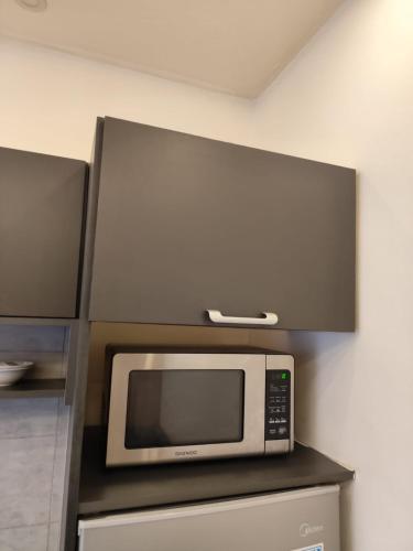 a microwave on top of a counter in a kitchen at Gentle Breeze Studio 3 in Amman