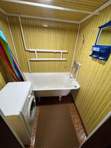 a bathroom with a sink and a washing machine at Lovely home for you in Osh