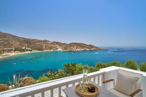 a balcony with a view of a beach and the ocean at Ios Palace Hotel & Spa in Mylopotas
