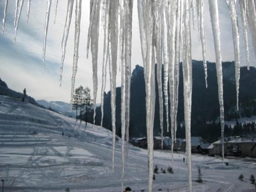 a bunch of icicles hanging over a snow covered slope at Hotel Gold in Terchová