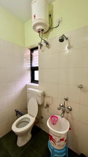 a bathroom with a toilet and a sink at Misty Mountain Kodaikanal in Kodaikānāl