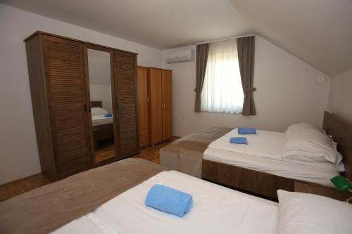 a bedroom with two beds and a window at Apartments Vila Leska in Zgornji Leskovec
