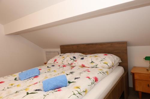 a bedroom with a bed with flowers on it at Apartments Vila Leska in Zgornji Leskovec