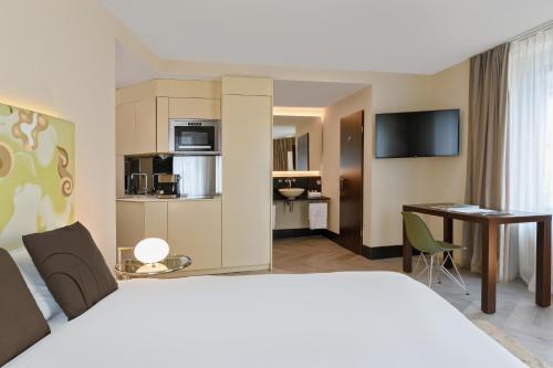 a hotel room with a bed and a desk at VISIONAPARTMENTS Brandschenkestrasse - contactless check-in in Zürich