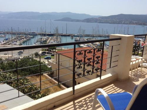 a view from a balcony of a city with a view of the ocean at Mantraki Hotel Apartments in Agios Nikolaos
