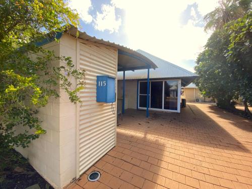 a small building with a blue box on the side of it at Osprey Holiday Village Unit 115 in Exmouth