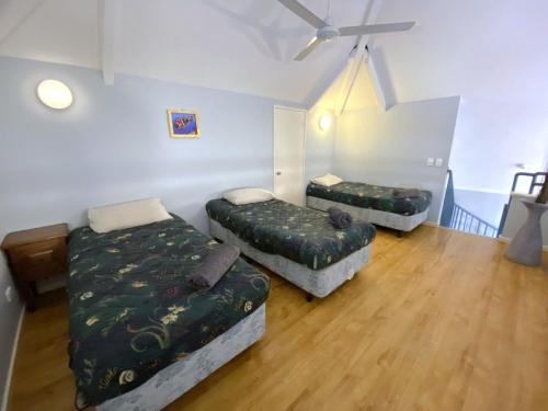 a living room with two beds and a couch at Osprey Holiday Village Unit 115 in Exmouth