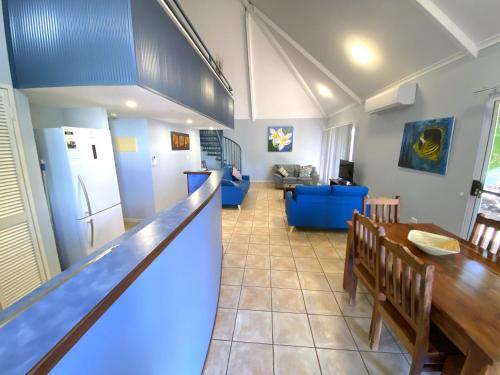 a kitchen and living room with a table and a refrigerator at Osprey Holiday Village Unit 115 in Exmouth