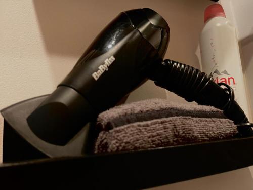 a black hair dryer in a box with a towel at Final 1room Condo WarszawaCenter in Warsaw