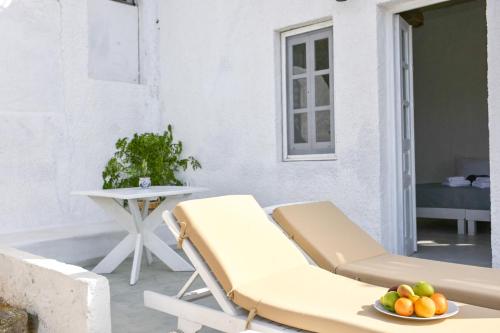 a couch and a bowl of fruit on a patio at Sapsila Patmos Residences in Sapsila