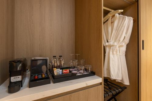 a room with a shelf with a toaster and glasses at Radisson Resort Layan Phuket in Layan Beach