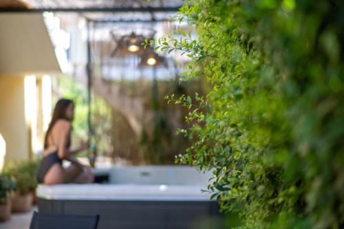 a woman sitting in a bathtub in a garden at Linas Home - Kalamata Mediterranean Villas in Kalamata