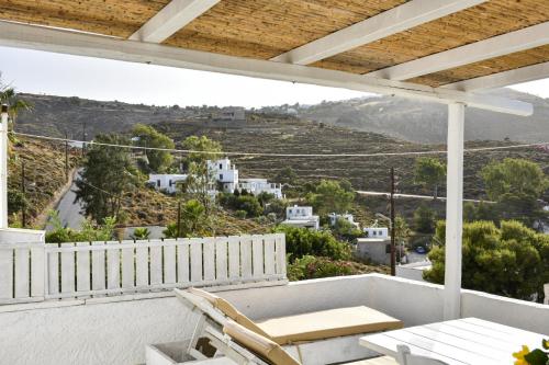 a balcony with a table and chairs and a view at Sapsila Patmos Residences in Sapsila