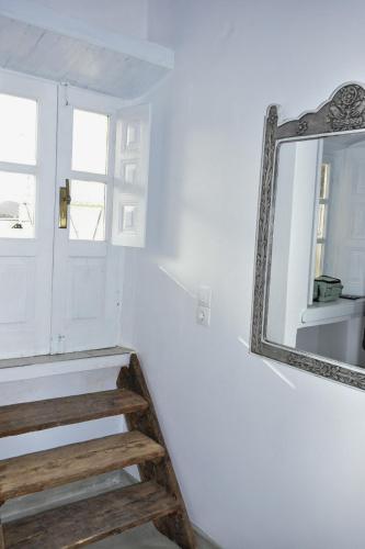 a staircase with a mirror next to a door at Sapsila Patmos Residences in Sapsila