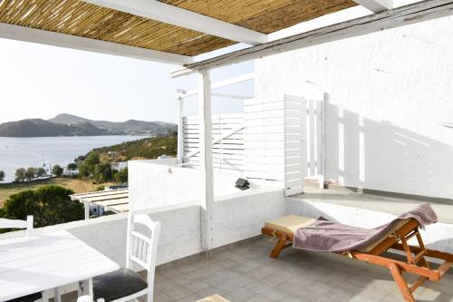 a balcony with a table and chairs and a view of the ocean at Sapsila Patmos Residences in Sapsila