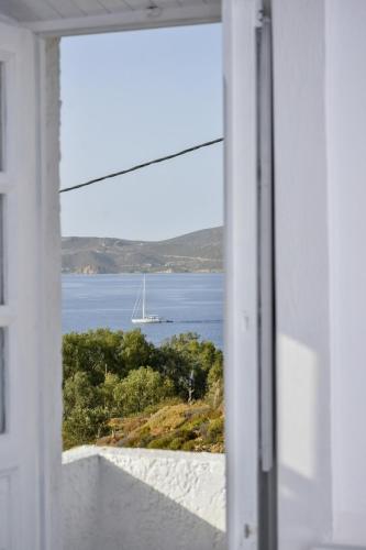 a window view of a sail boat in the water at Sapsila Patmos Residences in Sapsila