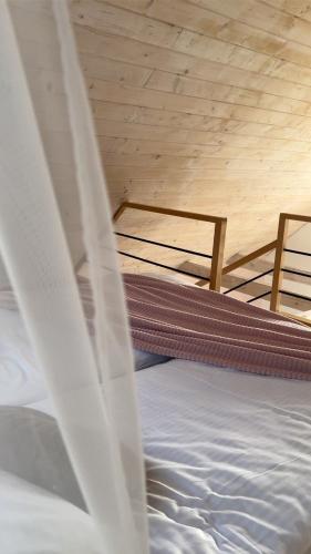 two bunk beds in a room with a wooden ceiling at Domki Dolina Roztocza in Zwierzyniec